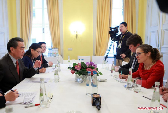 Chinese Foreign Minister Wang Yi (1st L) meets with his Canadian counterpart Chrystia Freeland (1st R) on the sidelines of the 53rd Munich Security Conference in Munich, Germany, on Feb. 18, 2017. (Xinhua/Luo Huanhuan)