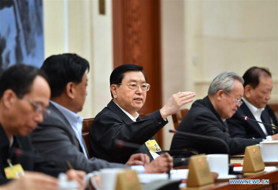 Zhang Dejiang (C), chairman of the Standing Committee of China's National People's Congress (NPC), attends panel discussions to review a report on the work of the NPC Standing Committee, which will be submitted to the annual session of the 12th NPC in March, in Beijing, capital of China, Feb. 23, 2017. (Xinhua/Li Tao)