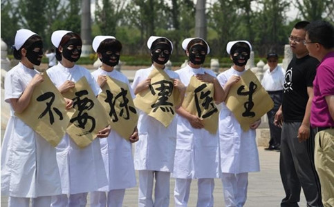Nurses from a hospital in Cangzhou, Hebei province, hold placards that say 'Don't vilify doctors' at an event in 2016. (Photo/China Daily)