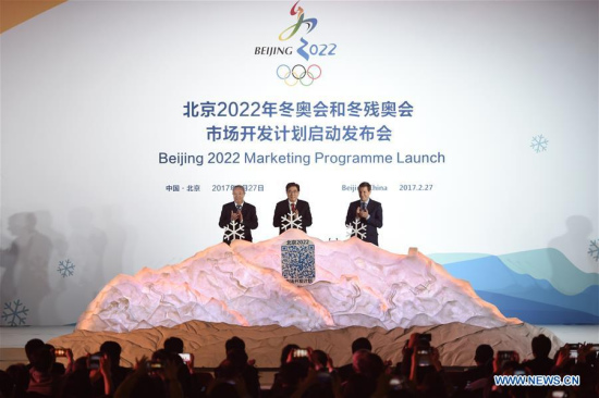 Beijing 2022 President Guo Jinlong (C), International Olympic Committee (IOC) Vice President Yu Zaiqing(L) and IOC Coordination Commission Chairman Alexander Zhukov clap after they put the white snowflake into a model of snow mountain to unlock the marketing program of Beijing 2022 Olympic and Paralympic Winter Games (Beijing 2022) in Beijing, capital of China, Feb. 27, 2017.  (Xinhua/Ju Huanzong)