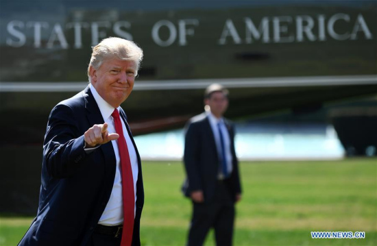 U.S. President Donald Trump (L) walks to the Oval Office after returning to the White House in Washington D.C., the United States, on Feb 24, 2017. (Xinhua/Yin Bogu)