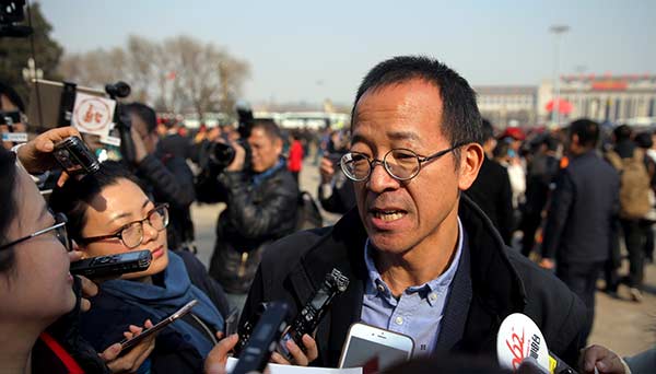 Yu Minhong answers questions in front of the Great Hall of the People in Beijing on Friday. HE HAI'ER/CHINA DAILY