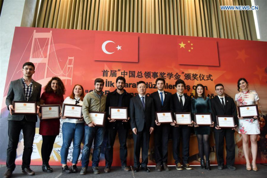 Qian Bo (C), the Chinese consul general in Istanbul, poses for a photo with students granted a scholarship at award ceremony in Istanbul, Turkey, on March 8, 2017. More than 60 Turkish students were granted a scholarship on Wednesday for their outstanding studies of the Chinese language. (Xinhua/He Canling)