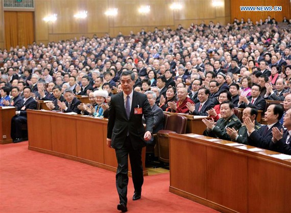 Leung Chun-ying walks to the rostrum after being elected vice chairman of the 12th National Committee of the Chinese People's Political Consultative Conference (CPPCC) at the closing meeting of the fifth session of the 12th CPPCC National Committee at the Great Hall of the People in Beijing, capital of China, March 13, 2017. (Xinhua/Liu Weibing)