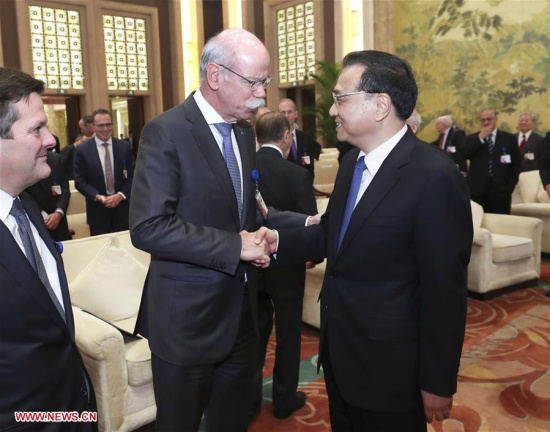 Chinese Premier Li Keqiang (R, front) shakes hands with Dieter Zetsche, chairman of Daimler AG and head of Mercedes-Benz Cars, when meeting with foreign representatives of the China Development Forum (CDF) 2017 in Beijing, capital of China, March 20, 2017. (Xinhua/Pang Xinglei)