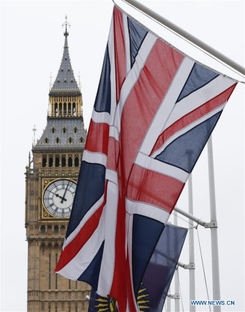 Photo taken on March 14, 2017 shows the Big Ben and the UK flag in central London, Britain. The British upper house of the Parliament passed the Brexit Bill Monday night, clearing the last hurdle for the government to trigger Brexit. (Xinhua/Han Yan)