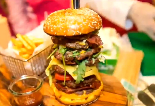 A colossal burger contains seven beef patties was sold for 10,000 U.S. dollars in Dubai. (Photo/Screenshot from CGTN)
