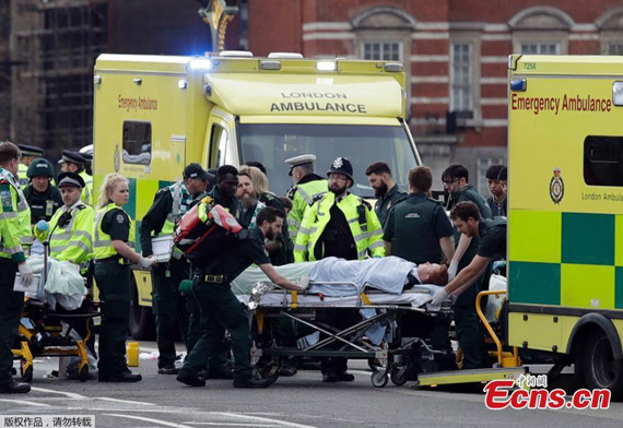 A man is treated by emergency services near Westminster Bridge and the Houses of Parliament on March 22, 2017 in London, England.Police cordon off the street outside the Houses of Parliament in London, Britain on March 22, 2017. Five people have been killed, including the stabbed officer and a male terrorist in an attack on the Houses of Parliament Wednesday afternoon in a terrorist attack, police announced.(Photo/Agencies)