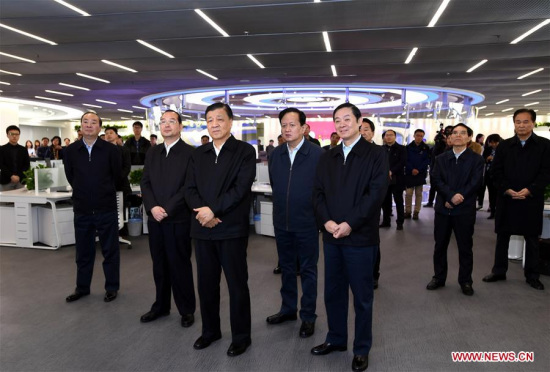 Liu Yunshan (C, front), a member of the Standing Committee of the Political Bureau of the Communist Party of China (CPC) Central Committee, views new media products at the People's Daily in Beijing, capital of China, March 22, 2017. (Xinhua/Rao Aimin)