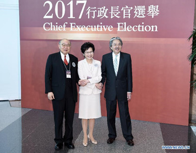 Candidates Tsang Chun-wah, Lam Cheng Yuet-ngor and Woo Kwok-hing (from R to L) pose for a photo in Hong Kong, south China, March 26, 2017. The voting for the fifth-term chief executive of China's Hong Kong Special Administrative Region (SAR) started on Sunday. (Xinhua/Wang Xi)