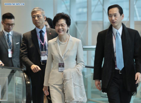 Lam Cheng Yuet-ngor (2nd R) arrives at the Hong Kong Convention and Exhibition Center before the voting for the fifth-term chief executive of China's Hong Kong Special Administrative Region (SAR), March 26, 2017. Lam Cheng Yuet-ngor wins the election of Hong Kong's fifth-term chief executive by obtaining more than 600 votes. (Xinhua/Wang Xi)