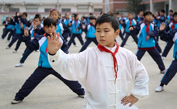 An elementary school student practices tai chi during a break in 2015 in Wenxian county, Henan province, where tai chi classes have been offered since 2001. XU HONGXING/CHINA DAILY