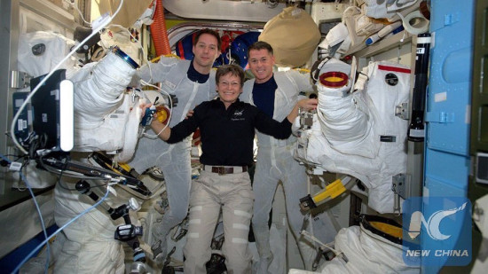 Astronaut Peggy Whitson (center) helps spacewalkers Thomas Pesquet (left) and Shane Kimbrough suit up before beginning their spacewalk Jan. 13, 2017.(Xinhua/Courtesy of NASA)
