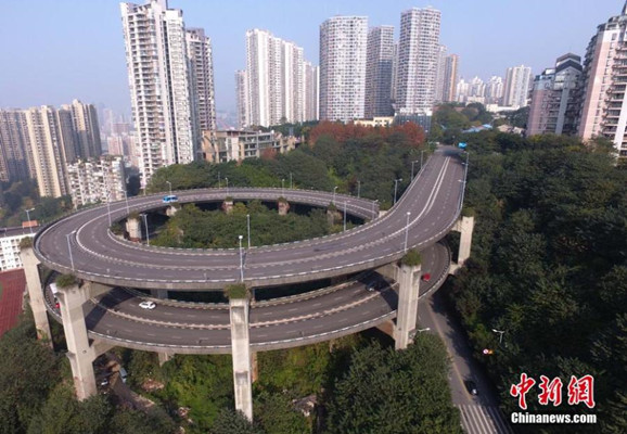 This photo taken on Dec. 16 shows a spiral bridge in Chongqing Municipality, southwest China. The bridge, called the Rongqiao Overpass, has become a landmark for the city, but it also raises debate among the locals. Some drivers say they are thrilled when driving through these sharp turns, while others say driving on it is just like riding a roller coaster and they don't like that feeling. (Photo/China News Service)