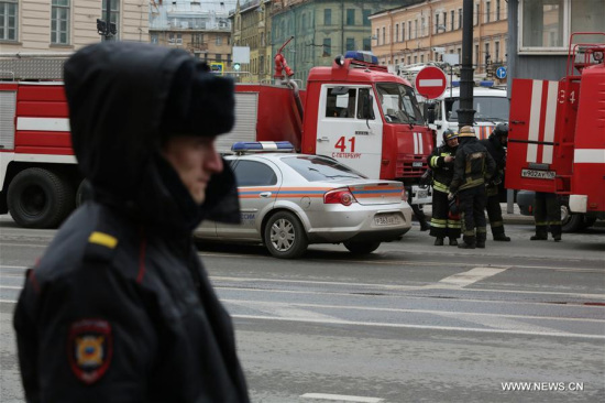 Policemen and firemen stand outside the metro station where a blast went off in St. Petersburg, Russia, on April 3, 2017. 