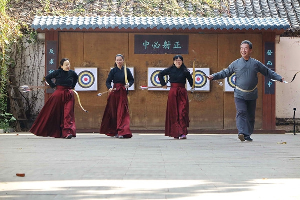 Zheng Haiting and three of his students practice his Kuixu ceremonial archery at Daming Lake in Jinan, Shandong province.Zhu Feng / For China Daily