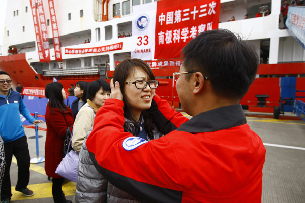 Scientists who arrived in Shanghai aboard the Xuelong icebreaker on Tuesday are reunited with their families after completing the nation's 33rd Antarctic expedition, which included surveying an airfield site. (Photo/Xinhua)