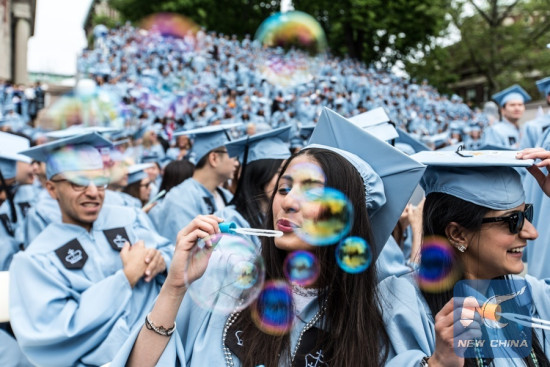 Members of the graduating class of 2016 blow bubbles during the Commencement ceremony of the 262nd Academic Year of Columbia University in New York, the United States on May 18, 2016. (Xinhua/Li Muzi)