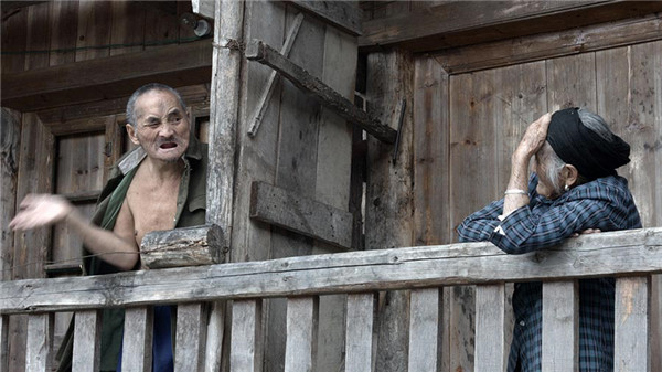 Documentary filmmaker Jin Xingzheng's Mama, featuring a woman (right) in her 80s who has long taken care of her mentally ill son (left), wins a top award at the first West Lake International Documentary Festival in Hangzhou. (Photo provided to China Daily)