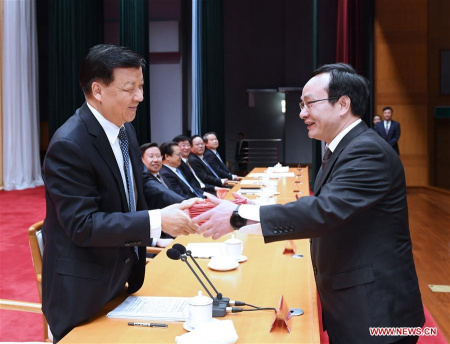 Liu Yunshan (L), president of the Party School of the Communist Party of China (CPC) Central Committee and member of the Standing Committee of the Political Bureau of the CPC Central Committee, awards certificates to a graduate during a spring semester graduation ceremony of the Party School in Beijing, capital of China, April 27, 2017. (Xinhua/Rao Aimin)