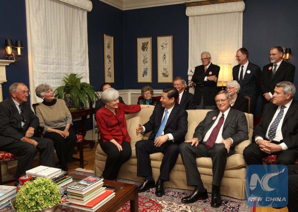 Photo taken on Feb. 15, 2012 shows Xi Jinping (3rd R, front), then Chinese Vice President, joined dozens of Americans for tea at a local house owned by his old friend Sarah Lande (3rd, L) in Muscatine, Iowa, the United States. (Xinhua/Lan Hongguang)