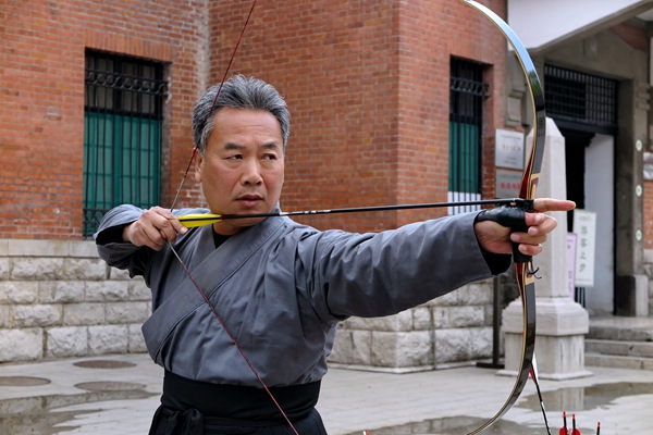 Zheng demonstrates an archery movement for his students.Zhu Feng / For China Daily