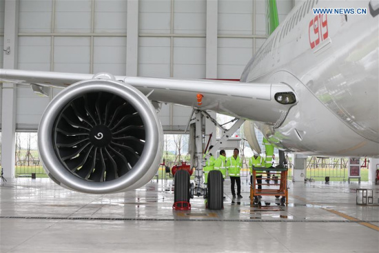 Staff workers check a C919, China's first domestically-built large passenger jet, at a hangar of the Commercial Aircraft Corporation of China (COMAC) in Shanghai, east China, May 4, 2017.  (Xinhua/Ding Ting)