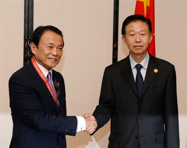 China's Finance Minister Xiao Jie (R) shakes hands with his Japanese counterpart Taro Aso during the sixth China-Japan bilateral finance dialogue in Yokohama, Japan, May 6, 2017. (Xinhua/Ma Ping)