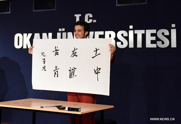 Ibrahim Zubeyir Agar displays his calligraphy at the 16th Chinese proficiency competition for Turkish college students in Istanbul, Turkey, on May 6, 2017. The 16th Chinese proficiency competition for college students in Turkey was held here on Saturday, with top ten winners offered a chance to visit China. (Xinhua/He Canling)