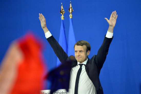 File photo taken on April 23, 2017 shows Emmanuel Macron, French presidential candidate for the On the Move (En Marche) movement, greeting his supporters at a rally after the first round of French presidential election in Paris, France. Macron, with 65.9 percent of vote, beats Le Pen in French runoff Presidential vote on Sunday, according to polling agency projections. (Xinhua/Jose Rodriguez)