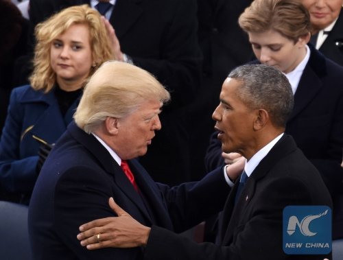 U.S. President DonaldTrump (L, front) is greeted by former U.S. President Barack Obama after delivering his inaugural address during the presidential inauguration ceremony at the U.S. Capitol in Washington D.C., the United States, on Jan. 20, 2017. (Xinhua/Yin Bogu)