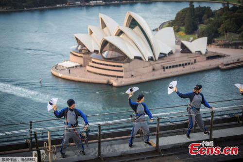 The Sydney Opera House appears above the Sydney Harbour Bridge, May 2, 2017, as the first tai chi class is conducted in Australia's largest city by the Australian Academy of Tai Chi and Qigong. (Photo/Agencies)