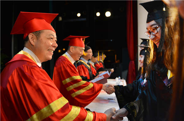 Yang Xianjin, Party chief of Tongji University, delivers diplomas to graduates in Shanghai in June 2016. Photos provided to China Daily