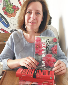 Suzana Li holds her translation of The Explosion Chronicles by Yan Lianke. (FU JING/CHINA DAILY)