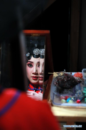 Zhang Jiachun, who plays the role of Gretchen, prepares backstage during the performance of experimental Peking opera Faust in Wiesbaden, west Germany, May 15, 2017. Experimental Peking opera Faust was staged Monday evening in Wiesbaden, starting its 15-day tour in Germany. (Xinhua/Luo Huanhuan)