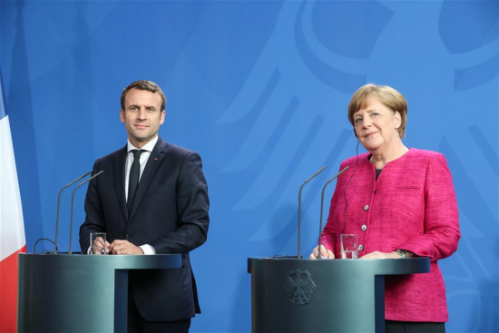 German Chancellor Angela Merkel (R) and visiting French President Emmanuel Macron attend a joint press conference in Berlin, capital of Germany, on May 15, 2017. (Xinhua/Shan Yuqi)