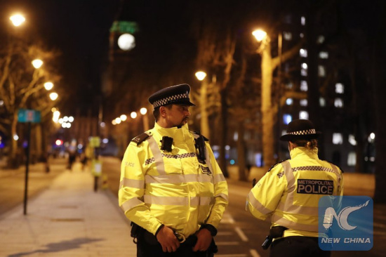 Two policemen stand guard outside the Houses of Parliament in London, Britain on March 22, 2017. (Xinhua/Han Yan)