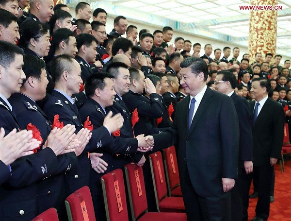 Chinese President Xi Jinping, also general secretary of the Central Committee of the Communist Party of China (CPC), Chinese Premier Li Keqiang and Liu Yunshan, a member of the Standing Committee of the Political Bureau of the CPC Central Committee, meet with heroes and role models from public security departments across the country at the Great Hall of the People in Beijing, capital of China, May 19, 2017. (Xinhua/Ju Peng)