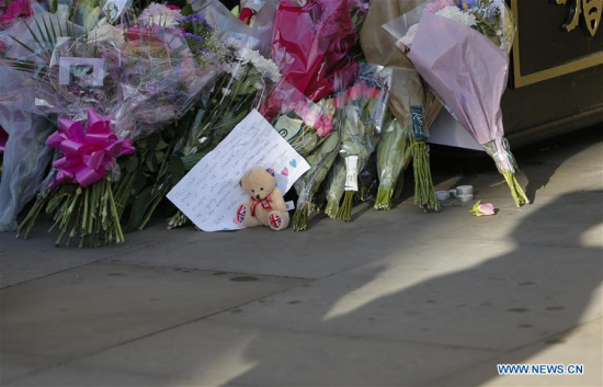 Flowers are placed during a candlelit vigil to mourn the victims of Manchester terror attack at Albert Square in Manchester, Britain on May 23, 2017. (Xinhua/Han Yan)