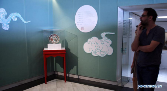 Visitors look at the ancient Chinese porcelain dish exhibited at the Benaki Museum in the Greek capital Athens on May 19, 2017. (Xinhua/Marios Lolos)