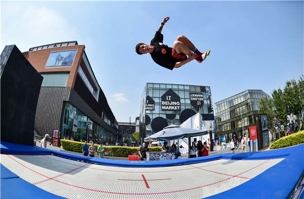 An outdoor sports enthusiast tests the trampoline at the Banff China film festival on May 20 in Beijing. Photos provided to China Daily
