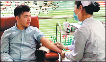 Tulenov Ruslan of Kazakhstan gets ready to give blood at a donation center in Beijing in February. He's so far donated over 5,000 milliliters, more than is in a human body.Provided Tochina Daily