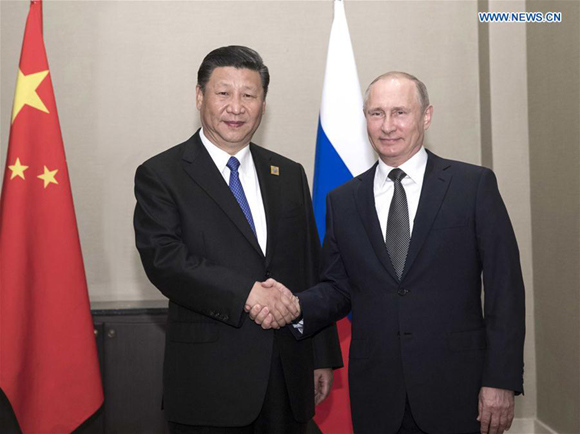Chinese President Xi Jinping (L) meets with Russian President Vladimir Putin in Astana, Kazakhstan, June 8, 2017. (Xinhua/Lan Hongguang)