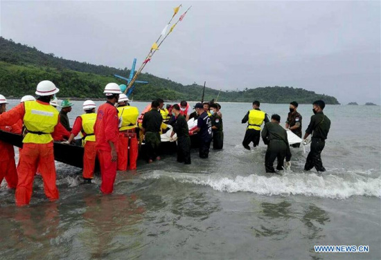 Rescuers carry the bodies of plane crash victims at a village of Laung Lone, southern Tanintharyi region, Myanmar, June 8, 2017. A total of 29 human bodies have been discovered at sea, according to a statement released by Myanmar's Defense Services Office Thursday afternoon. (Xinhua/Defense Services Office)