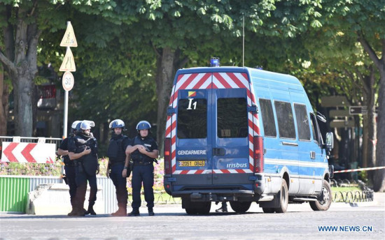Police officers patrol near the Champs-Elysees avenue on June 19, 2017 in Paris, France. A car rammed into a police van Monday on the Champs-Elysees avenue in Paris before bursting into flames, French Interior Minister Gerard Collomb said. (Xinhua/Li Genxing)
