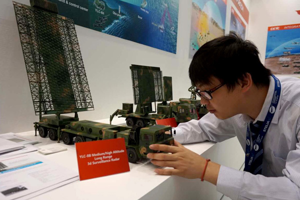 A worker at China Electronics Technology Group Corp sets up a model of the YLC-8B air-defense radar on Wednesday at the 52nd International Paris Air Show at Paris-Le Bourget Airport. Provided To China Daily