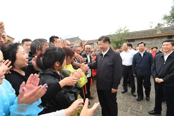 Chinese President Xi Jinping meets with local villagers at Songjiagou New Village, a centralized resettlement site under the approach of alleviating poverty through relocation, in Kelan County of Xinzhou City, north China's Shanxi Province, June 21, 2017. Xi had a three-day inspection tour in Shanxi from Wednesday. (Xinhua/Li Xueren)