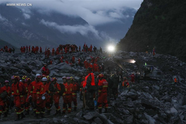 Rescuers work at the accident site after a landslide occurred in Xinmo Village of Maoxian County, Tibetan and Qiang Autonomous Prefecture of Aba, southwest China's Sichuan Province, June 24, 2017. Fifteen people have been confirmed dead in the landslide in Sichuan early Saturday that buried more than 120 people from 62 homes. (Xinhua/Jiang Hongjing)
