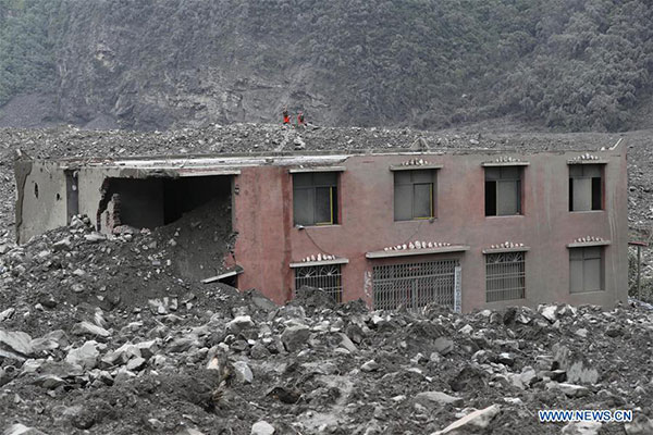 Rescuers work at the accident site after a landslide occurred in Xinmo village of Maoxian county, Tibetan and Qiang autonomous prefecture of Aba, Southwest China's Sichuan province, June 24, 2017. The rescue headquarters of the landslide in Sichuan province has said the landslide buried 62 homes, and more than 120 people are thought to be missing. Currently, more than 1,000 workers with life-detection instruments are engaged in the search for survivors. (Photo/Xinhua)