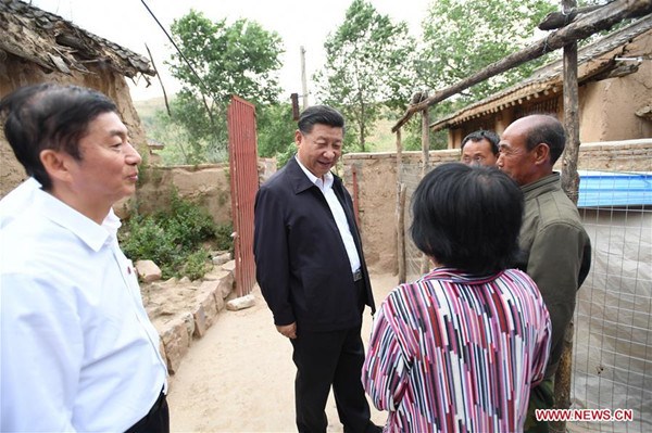 Chinese President Xi Jinping (C) visits the poverty-stricken family of Cao Liuren (1st R) in Zhaojiawa Village of Kelan County in Xinzhou City, north China's Shanxi Province, June 21, 2017. Xi had an inspection tour in Shanxi Wednesday. (Xinhua/Li Xueren)